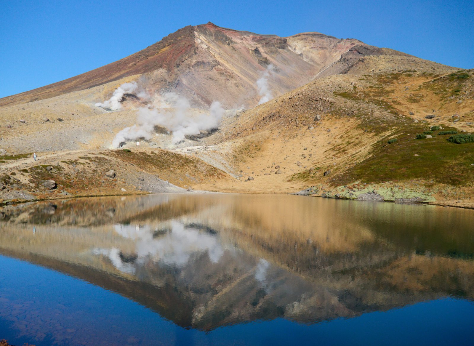 Sugatami Pond reflecting the volcanic peak of Mount Asahidake in Daisetsuzan