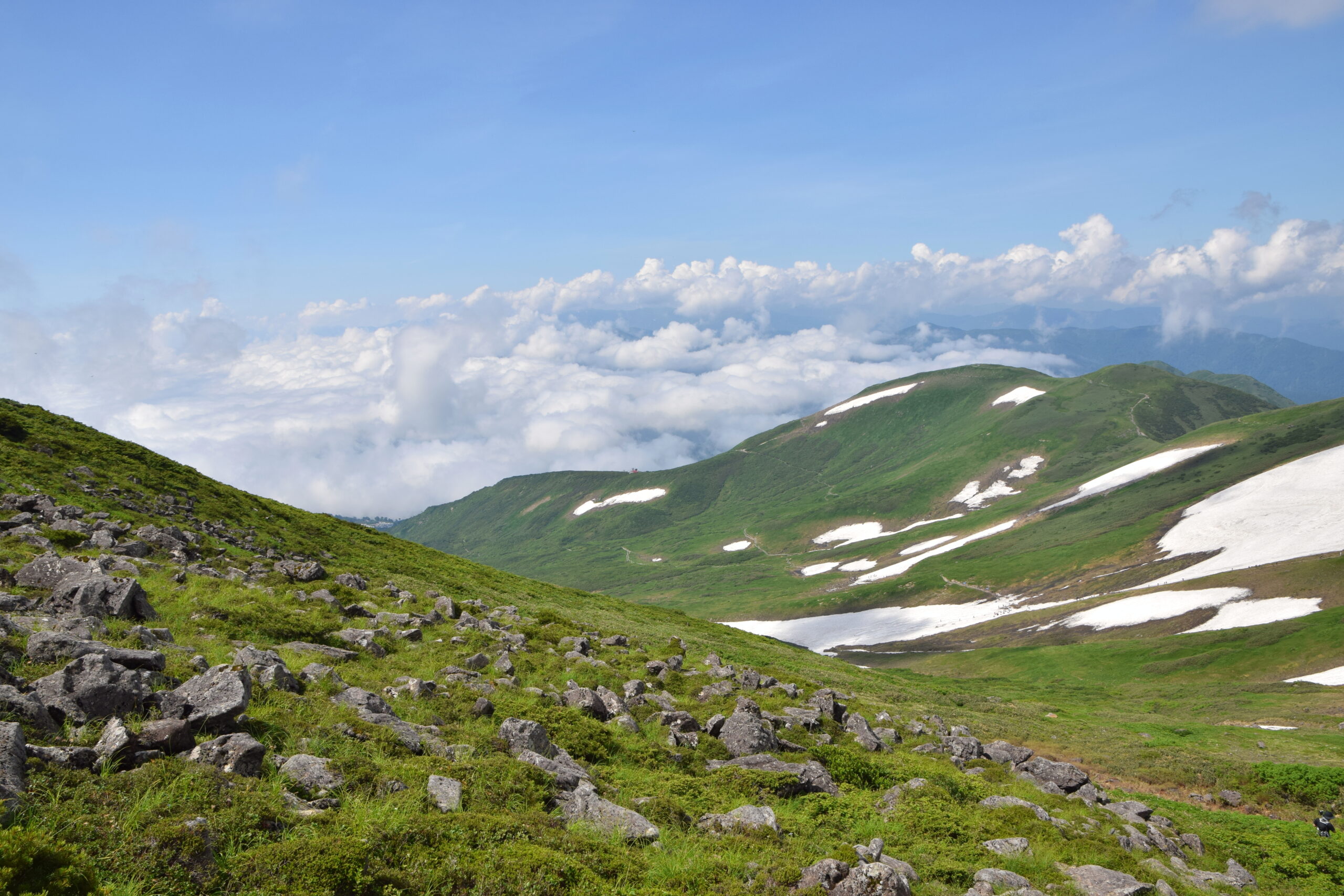 Mount Gassan rising above green slopes in Yamagata