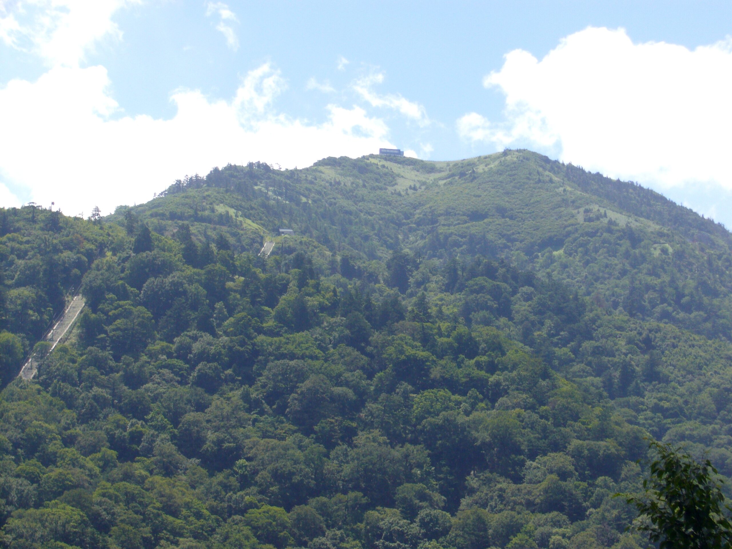 Ken-zan (Mount Tsurugi), the 1,955-metre peak in Tokushima Prefecture, Shikoku, seen from the Minokoshi trailhead, with the summit hutte on the top and the chairlift line climbing its flank