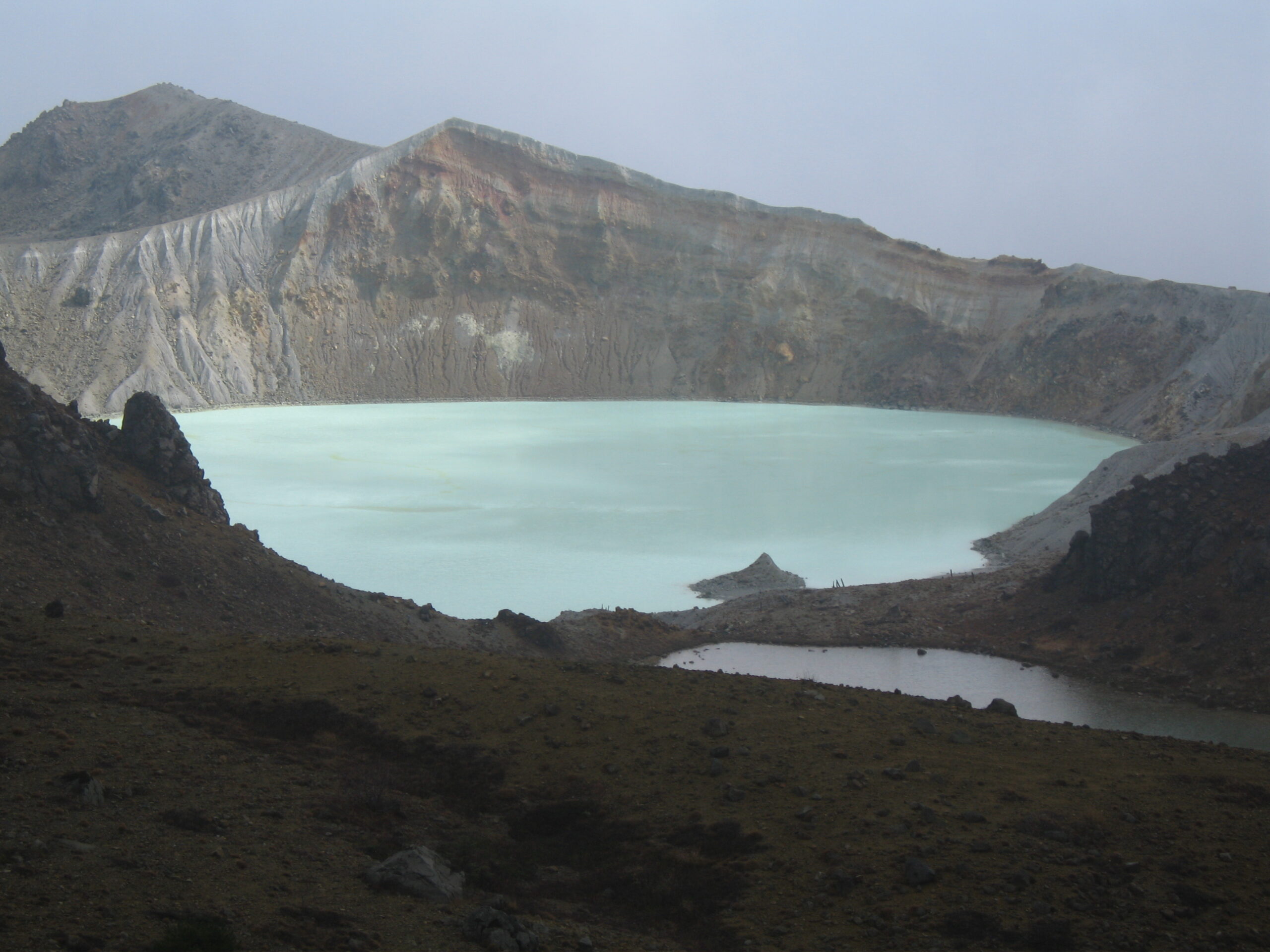 The milky-green crater lake Yugama on Mount Kusatsu-Shirane