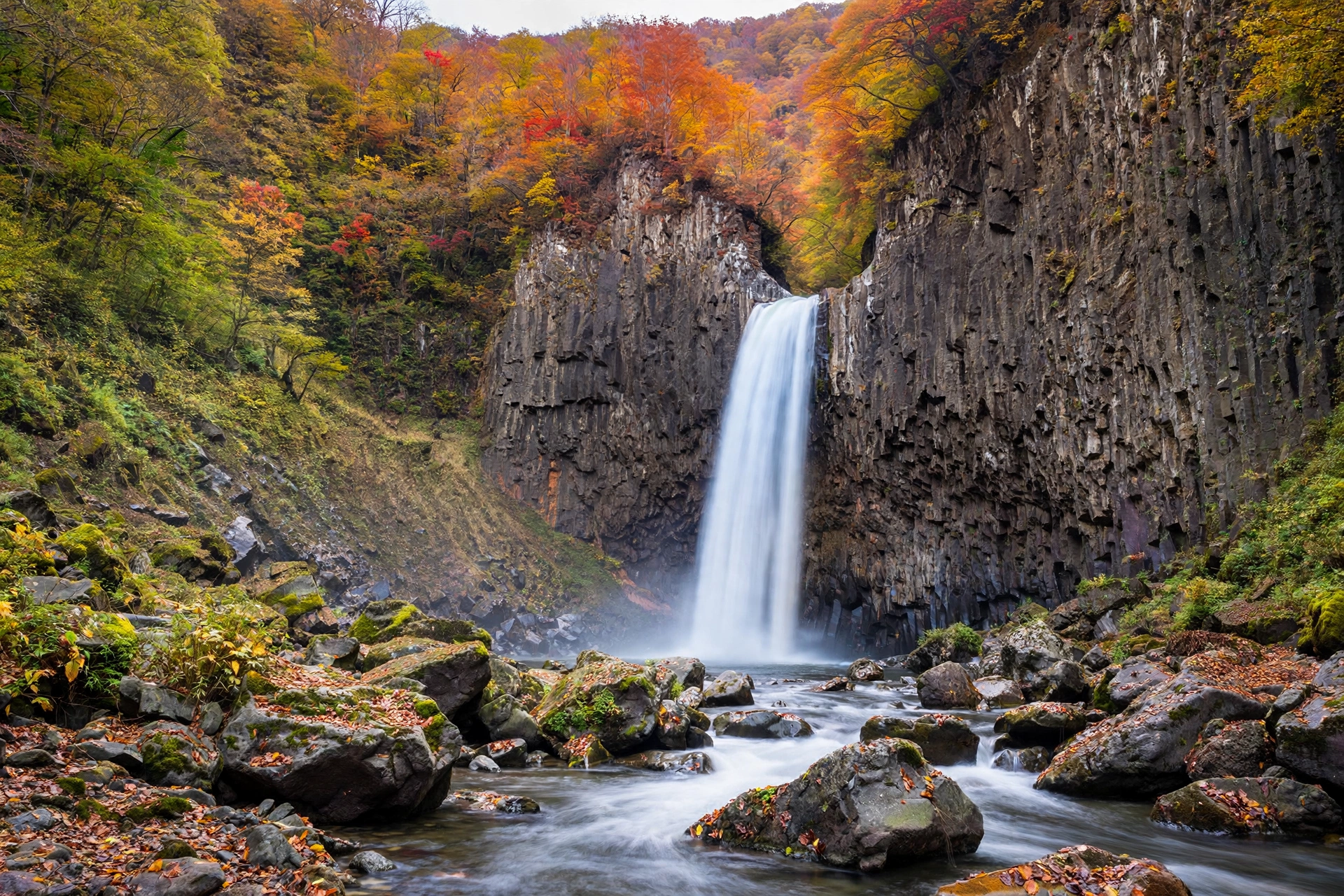 Naena Falls cascading over basalt cliff in Myoko, Japan