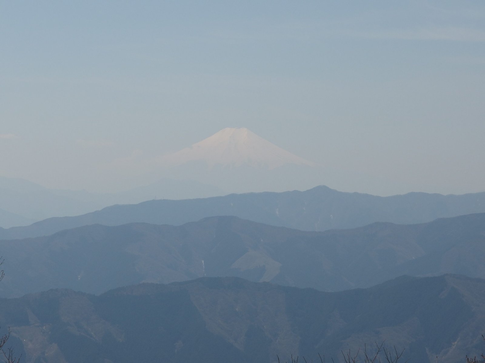Mount Fuji on the horizon viewed from the summit of Mount Odake